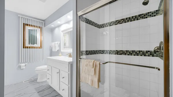 a view of a bathroom with a tub shower a sink and a toilet