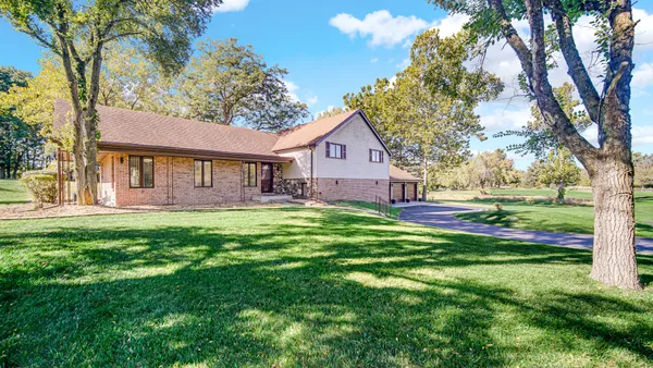 a front view of house with yard and green space