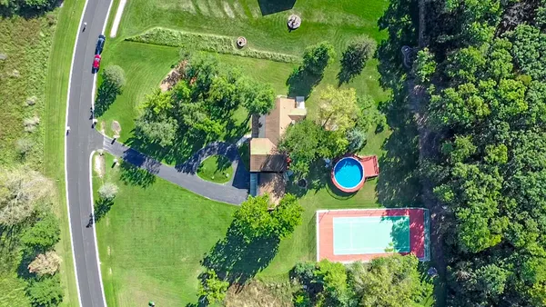 view of a house with a yard and garden