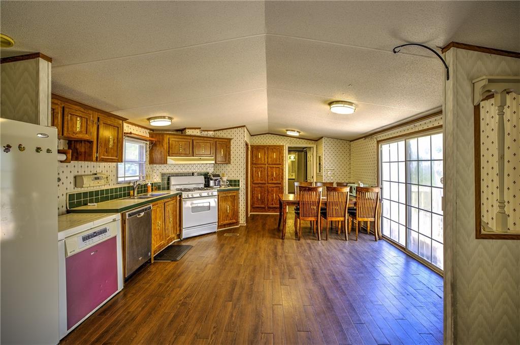 4201 Dunagan Road Gainesville, GA 30507 - Photo 18 of 37 a kitchen with lots of counter top space and wooden floor