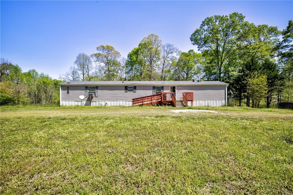 4201 Dunagan Road Gainesville, GA 30507 - Photo 2 of 37 a front view of a house with a garden and tree