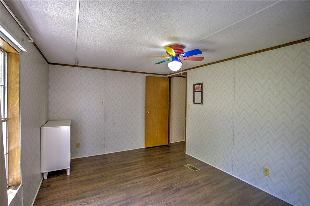 4201 Dunagan Road Gainesville, GA 30507 - Photo 29 of 37 a view of an empty room with wooden floor and a window