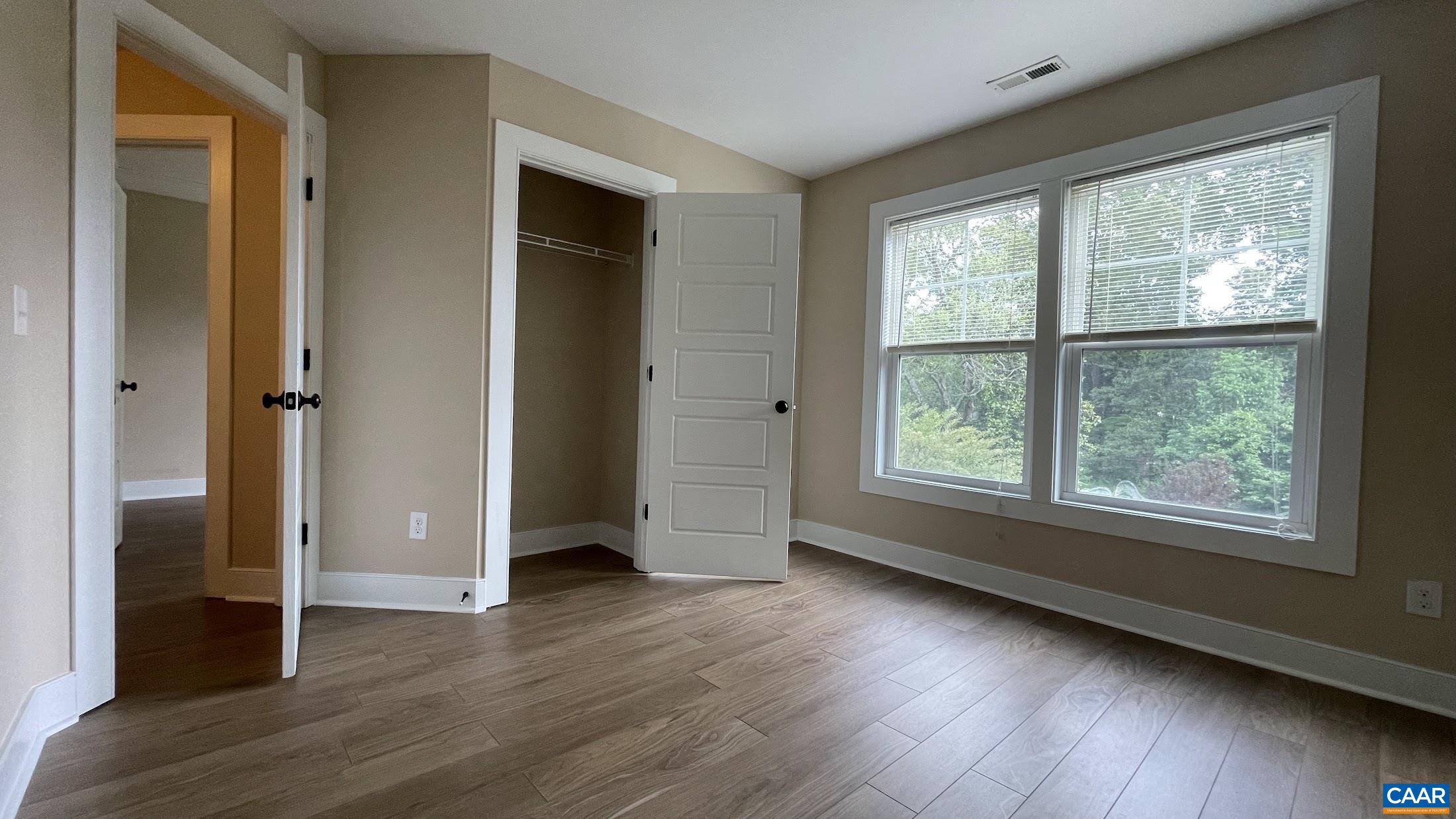 200 Harris Road Charlottesville, VA 22903 - Photo 23 of 28 an empty room with wooden floor and windows
