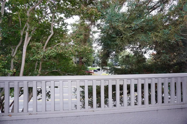 a wooden fence with trees in the background