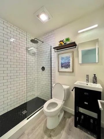 a bathroom with a toilet a sink and mirror