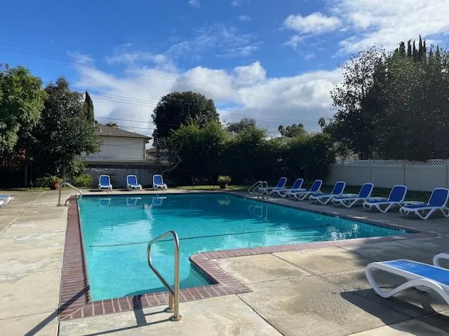 a view of a swimming pool with lounge chairs
