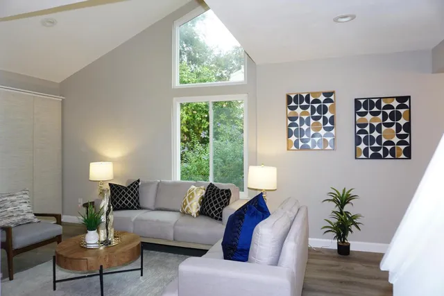 a living room with furniture and a large window