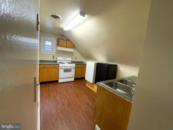 a kitchen with stainless steel appliances a stove a microwave and a refrigerator