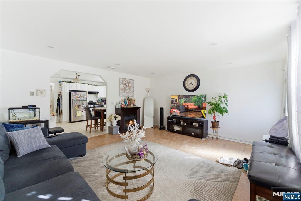 270 Westervelt Place Lodi, NJ 07644 - Photo 3 of 17 a living room with furniture and a fireplace