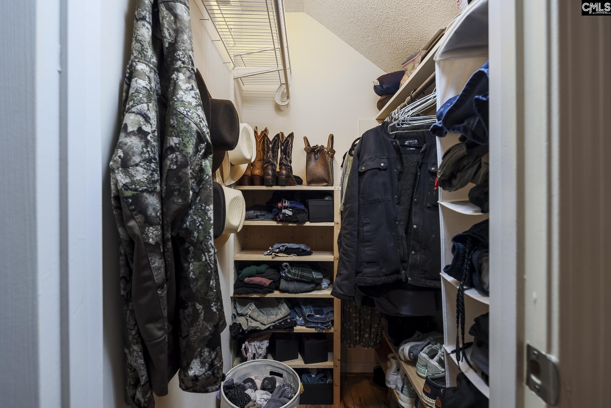 152 Thames Valley Court Irmo, SC 29063 - Photo 25 of 32 a view of walk in closet with clothes and shoes