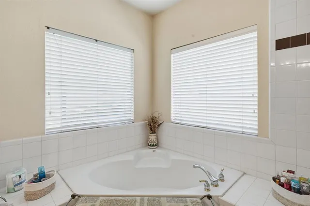 a bathroom with a bathtub and a window