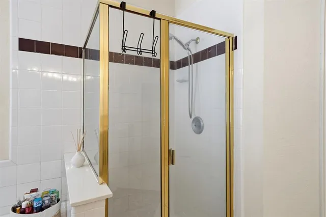 a bathroom with a shower and a mirror