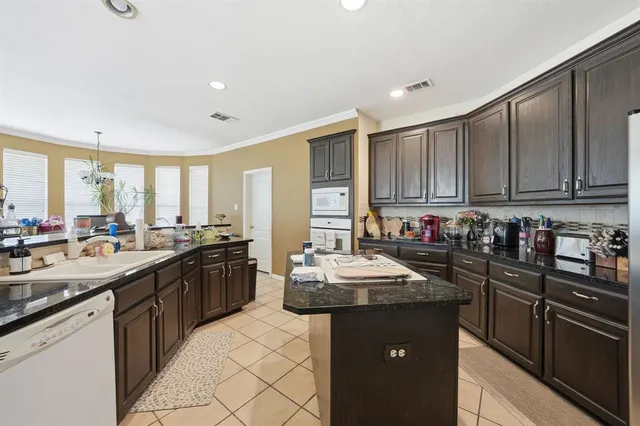 a kitchen with sink cabinets and stainless steel appliances