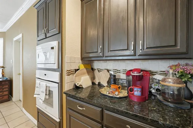 a kitchen with granite countertop cabinets and stainless steel appliances
