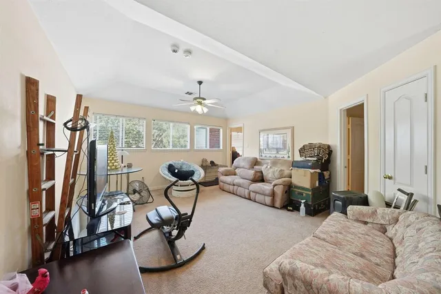 a living room with furniture a gym equipment and a large window