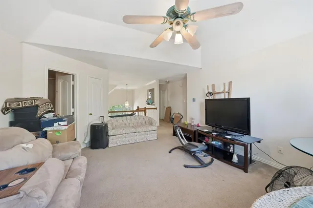 a view of a livingroom with workspace and a window