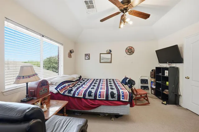 a bedroom with bed and a window