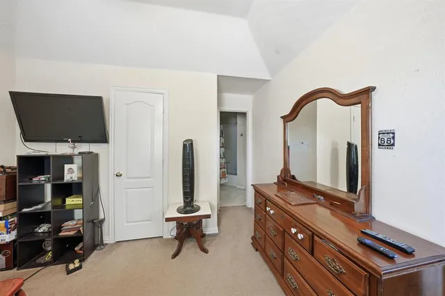 a room with chairs a flat screen tv and gym equipment