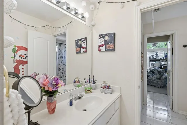 a bathroom with a sink mirror and vanity