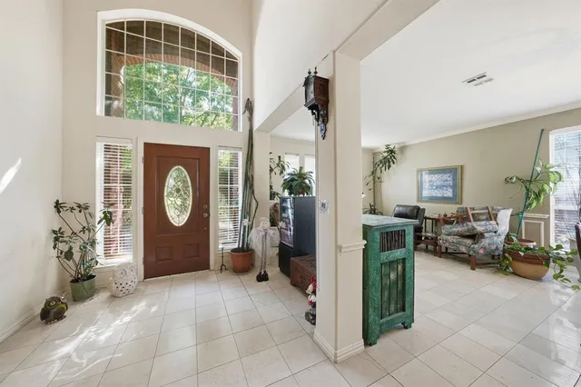 a living room with furniture a window and a clock on the wall