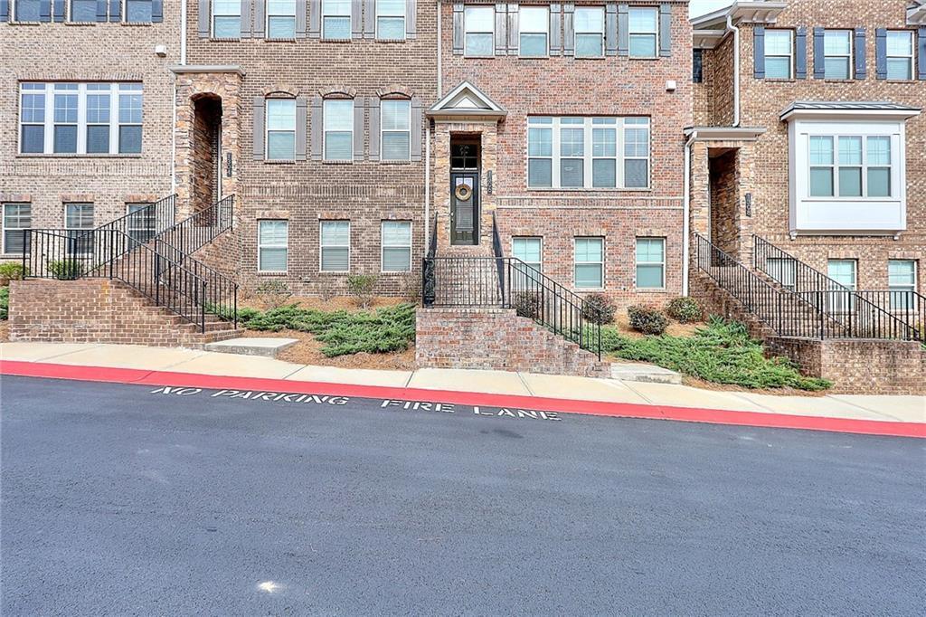 1306 Harris Way South Atlanta, GA 30319 - Photo 18 of 19 a view of a brick house with a yard and large tree