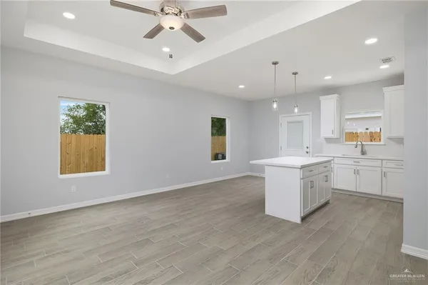 an empty room with a window and wooden floor