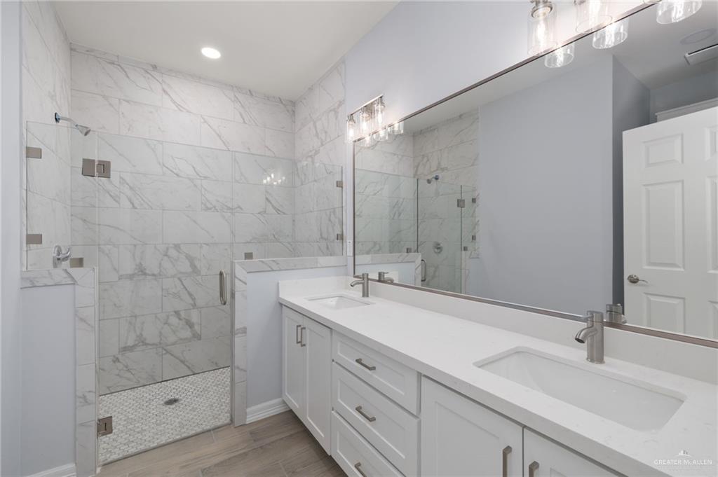 412 East Acacia Avenue, Unit 1 Alamo, TX 78516 - Photo 16 of 22 a bathroom with a double vanity sink mirror and shower