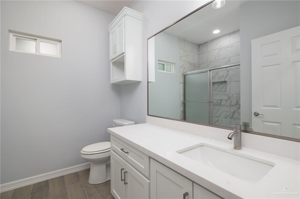 412 East Acacia Avenue, Unit 1 Alamo, TX 78516 - Photo 18 of 22 a bathroom with a sink toilet and shower