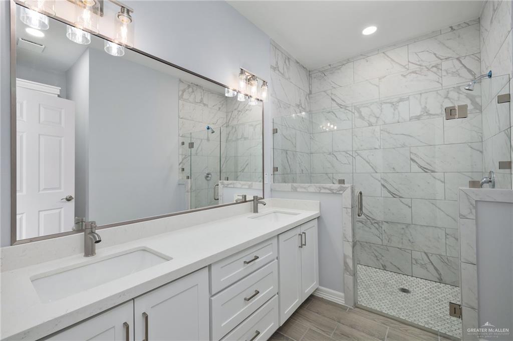 412 East Acacia Avenue, Unit 1 Alamo, TX 78516 - Photo 7 of 22 a spacious bathroom with a shower sink and mirror