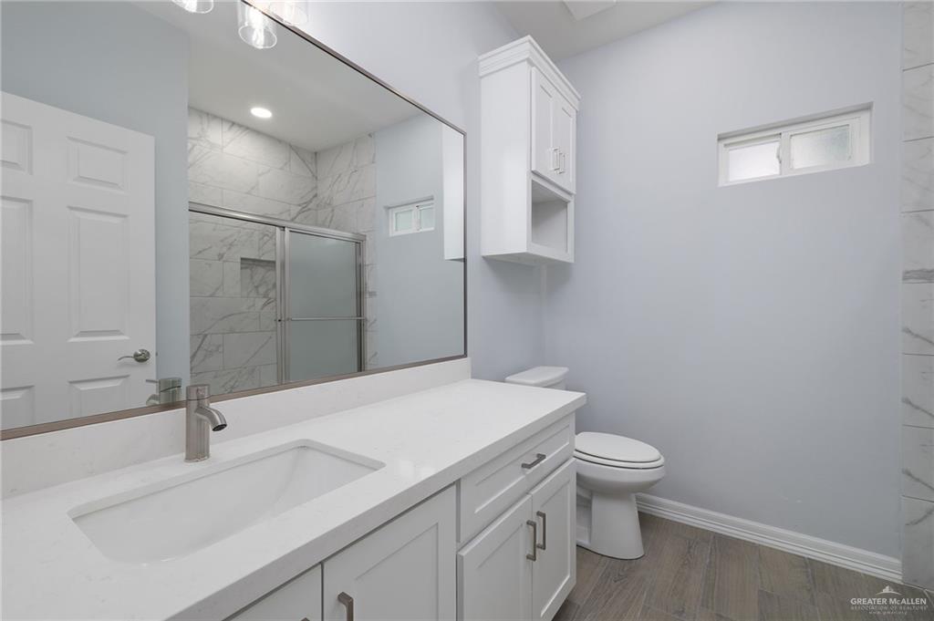 412 East Acacia Avenue, Unit 1 Alamo, TX 78516 - Photo 9 of 22 a bathroom with a sink toilet and shower