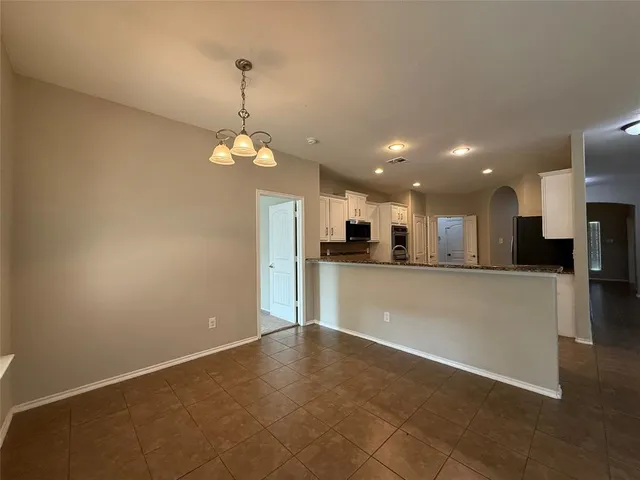 a view of a kitchen with a sink and a refrigerator