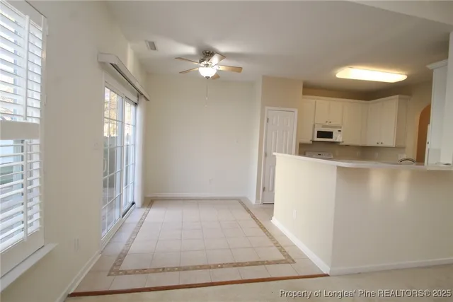 a kitchen with a sink refrigerator and cabinets