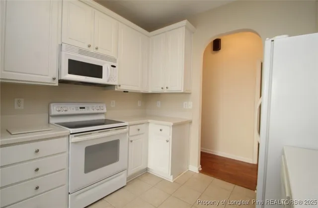 a kitchen with cabinets stainless steel appliances and a sink