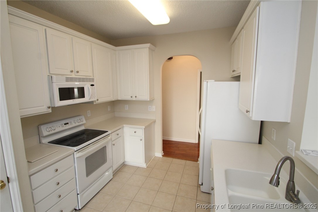 8508 Neuse Garden Drive Raleigh, NC 27616 - Photo 16 of 44 a kitchen with a refrigerator sink and cabinets