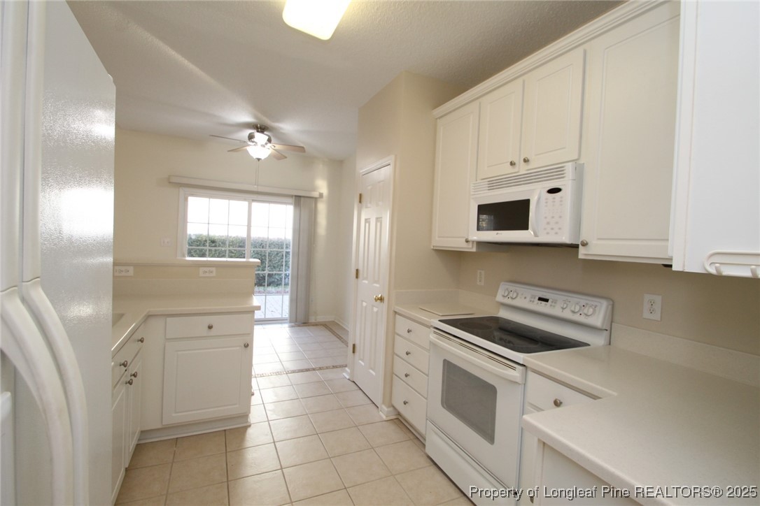 8508 Neuse Garden Drive Raleigh, NC 27616 - Photo 17 of 44 a kitchen with white cabinets and appliances