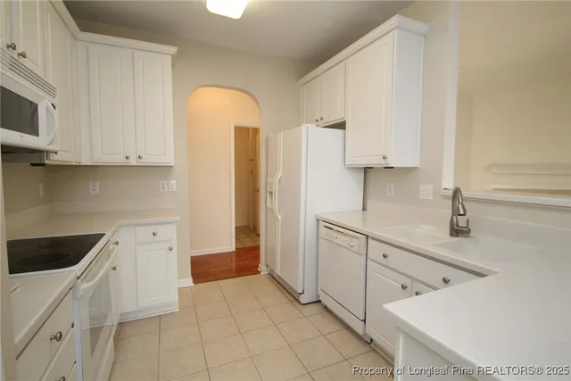 a kitchen with a sink and chandelier