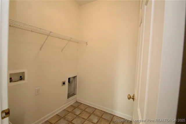 an empty room with windows and ceiling fan