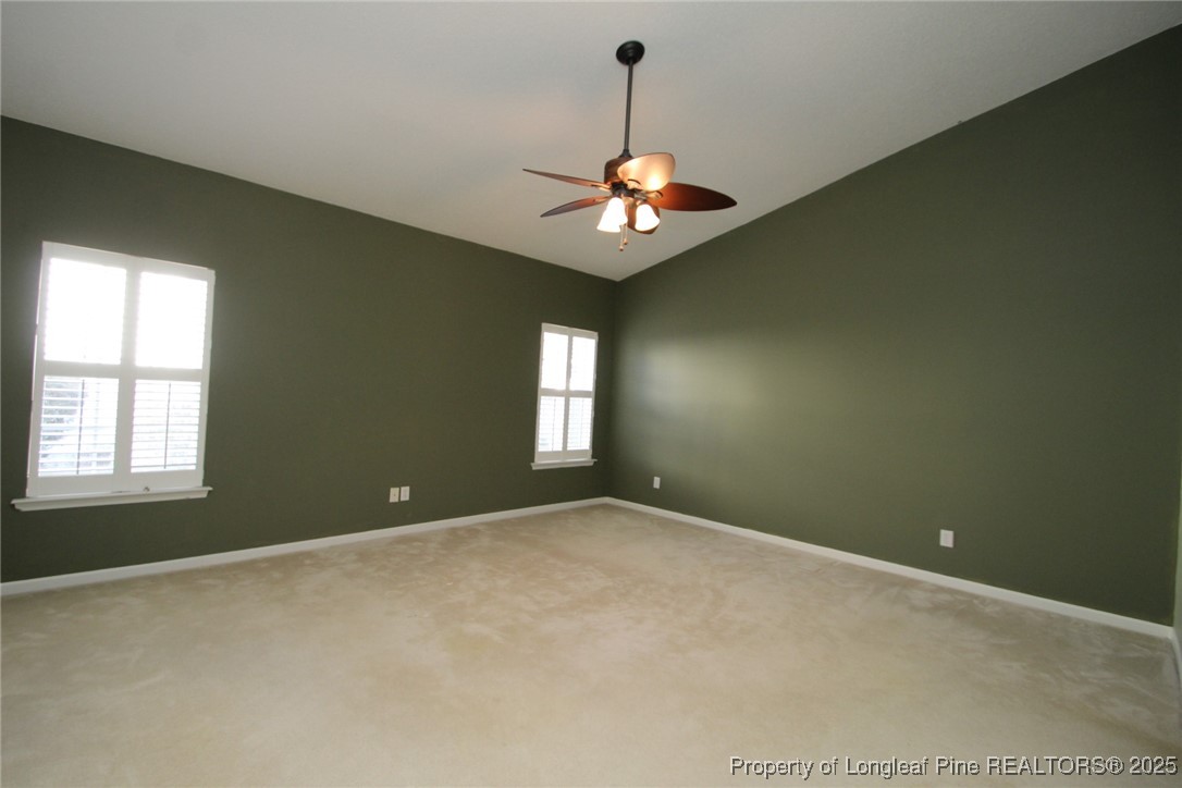 8508 Neuse Garden Drive Raleigh, NC 27616 - Photo 22 of 44 an empty room with windows and ceiling fan
