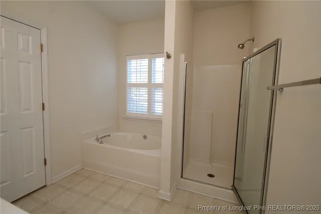 a spacious bathroom with a toilet a sink and mirror