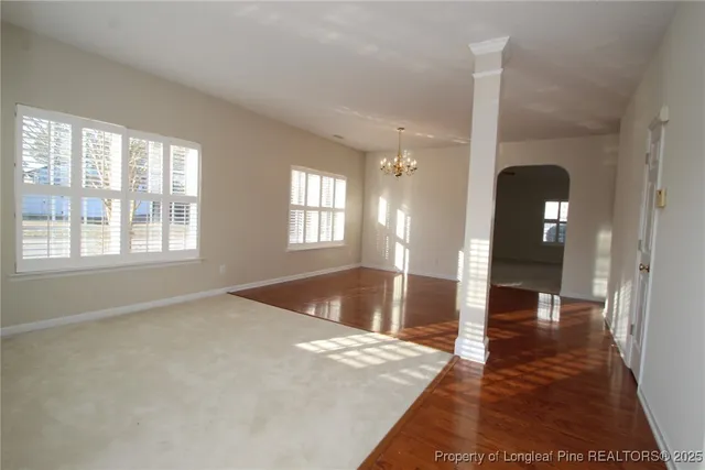 a view of a livingroom with a furniture wooden floor and windows
