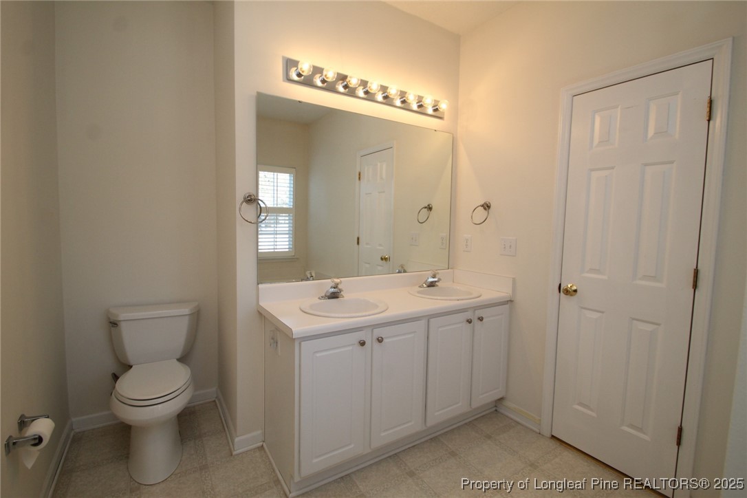 8508 Neuse Garden Drive Raleigh, NC 27616 - Photo 31 of 44 a spacious bathroom with a toilet a sink and mirror