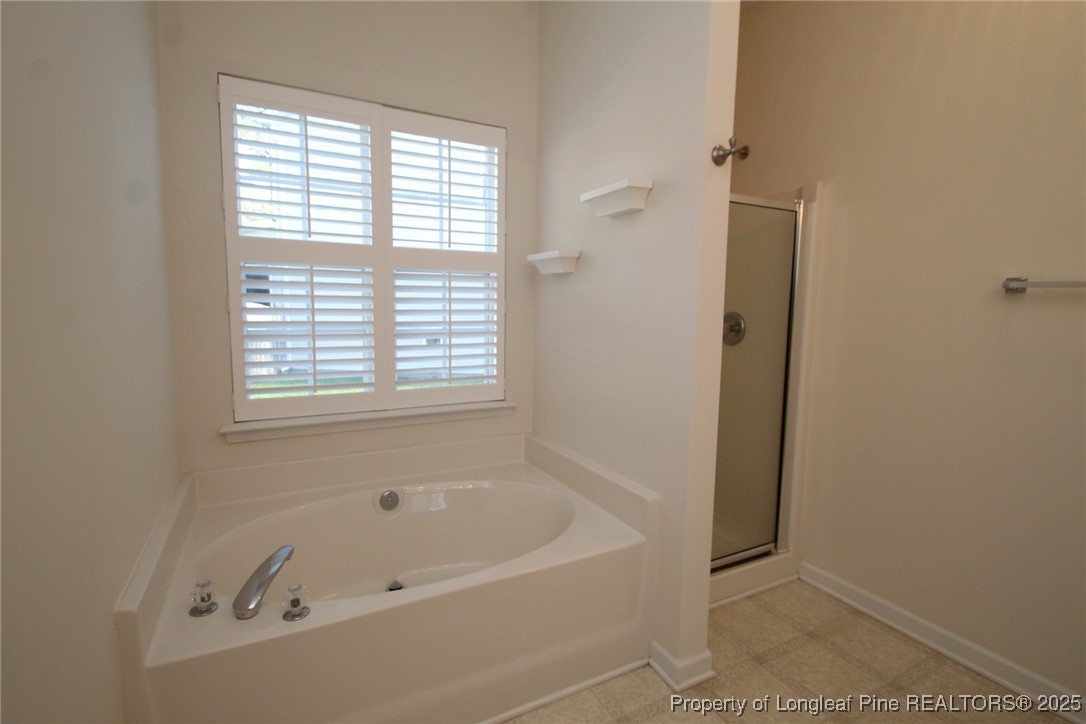 8508 Neuse Garden Drive Raleigh, NC 27616 - Photo 32 of 44 a white bath tub sitting next to a window