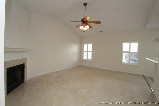a view of empty room with a fireplace
