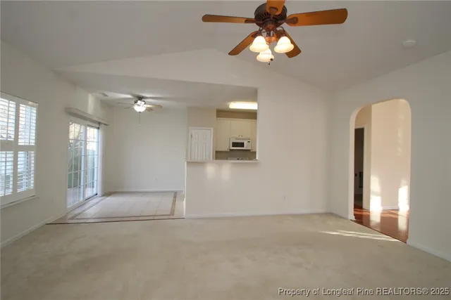 a view of a kitchen with wooden floor and a kitchen space