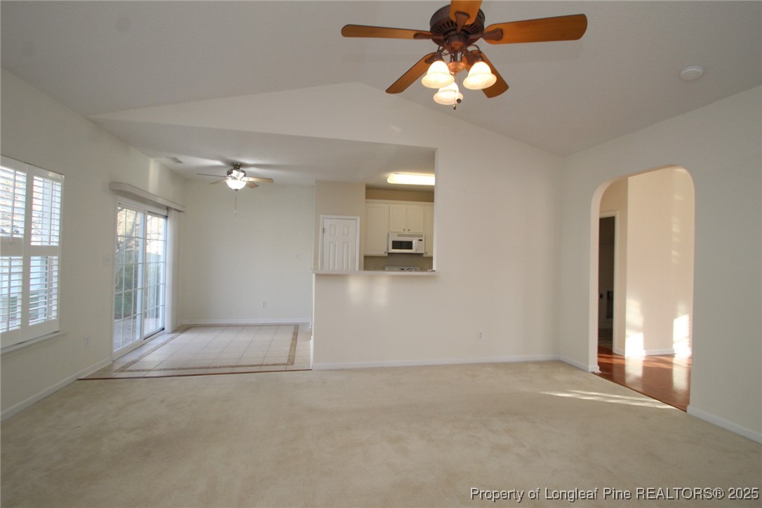 8508 Neuse Garden Drive Raleigh, NC 27616 - Photo 10 of 44 an empty room with chandelier fan and windows