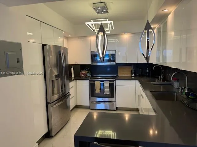 a kitchen with stainless steel appliances a refrigerator a stove and a sink