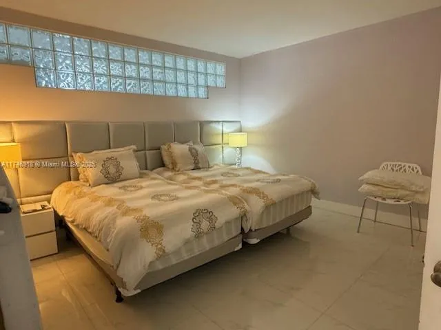 a bedroom with a bed and window