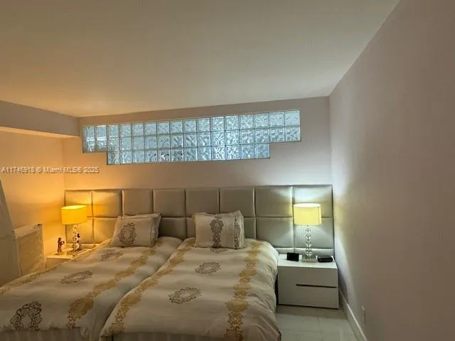a bedroom with a bed and lamp
