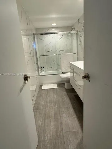 a bathroom with a shower and a toilet