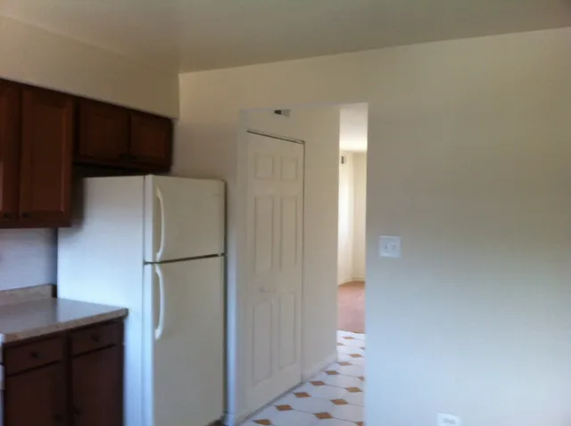 a white refrigerator freezer and a stove sitting inside of a kitchen